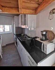 a kitchen with a sink and a counter top at Casinhas Proença in Aljezur