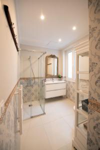 a bathroom with a shower and a sink and a mirror at Heart of Pamplona Palace in Pamplona