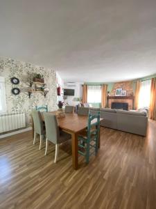 a living room with a wooden table and chairs at Casa Rural La Higuera in Ruidera +46 photos