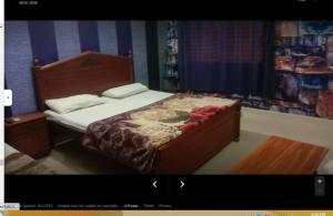 a bedroom with a bed with flowers on it at Grace Hotel in Gobindpur