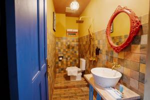 a bathroom with a sink and a mirror at Por Aqui Stay & Dine in Yogyakarta