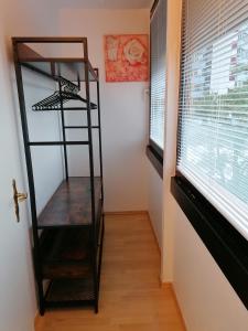 a room with a book shelf and a window at 1 Person - Single - Appartement -Zentral gelegen in Leverkusen Wiesdorf - Friedrich Ebert Platz 5a , 4te Etage mit Aufzug-und mit Balkon in Leverkusen