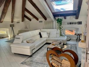 a living room with a white couch and a table at Addicted to Paradise b&b in Trieste
