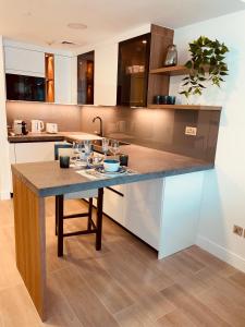 a kitchen with a large island in the middle at Luxury apartment on the metro facing Dubai Marina in Dubai