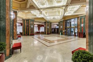 a large room with a large lobby with a large ceiling at Natsionalny Hotel in Kyiv