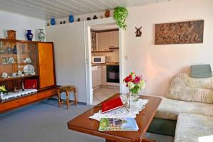 a living room with a couch and a table at Ferienwohnung Tammer in Schirgiswalde