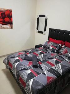 a bedroom with a bed with a colorful quilt at Afsaal flats in Amanzimtoti