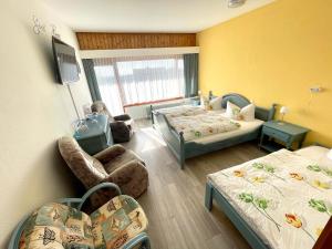 Postel nebo postele na pokoji v ubytování Hotel Charlott