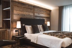 Postel nebo postele na pokoji v ubytování Hotel Alù Mountain Design