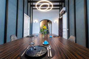 a dining room table with a plate on top of it at Riflessi Acireale Palace Suites in Acireale