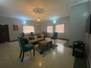 a living room with a couch and a table and chairs at Vintage Homes Lekki in Lagos