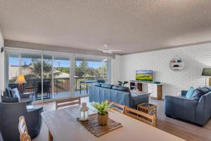 a living room with a couch and chairs and a table at Wintersview 2 - Lennox Head in Lennox Head