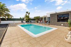a swimming pool in the backyard of a villa at Lanzarote Villa Irina Marina Rubicón in Playa Blanca