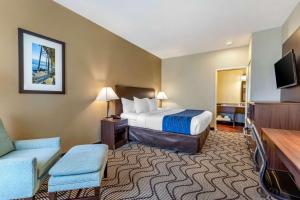 a hotel room with a bed and a flat screen tv at Comfort Inn & Suites Orange County John Wayne Airport in Santa Ana