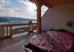 a bedroom with a view of the ocean on a balcony at Pipe in Metajna