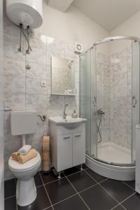 a bathroom with a shower and a toilet and a sink at Holiday Home Dijamant in Kučiće