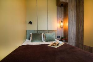 a bedroom with a bed with a tray on it at W&K Apartments - Balance Suite in Koszalin