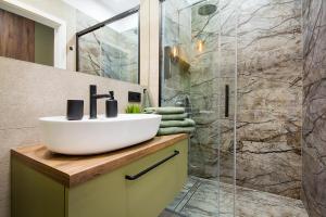 a bathroom with a sink and a shower at W&K Apartments - Balance Suite in Koszalin