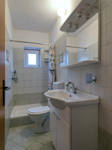a bathroom with a sink and a toilet and a tub at Pipe in Metajna +40 photos