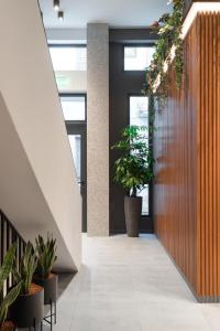 a hallway with potted plants in a building at 11 Enteka Acropolis Suites in Athens