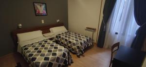 Ein Bett oder Betten in einem Zimmer der Unterkunft Hostal Felipe V