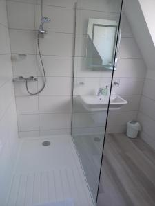 a bathroom with a shower, toilet and sink at Trelawne Hotel in Falmouth