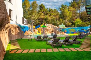 a playground with chairs and a water park at Apartaments Els Llorers in Lloret de Mar