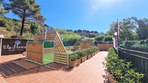 a garden with a play structure on a patio at Apartaments Els Llorers in Lloret de Mar