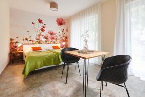 a bedroom with a bed and a table and chairs at Bei Meyers - Leipzig Neue Messe in Leipzig