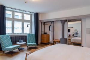 Un pat sau paturi într-o cameră la Marktgasse Hotel