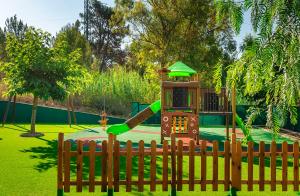 a playground with a slide in a park at Apartaments Els Llorers in Lloret de Mar
