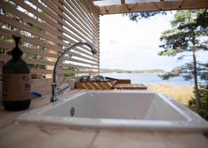 a kitchen sink with a view of the water at Glamping in the Trosa Archipelago in Trosa