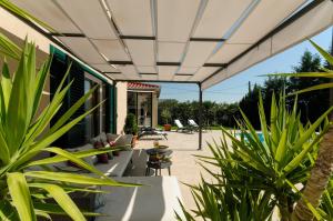 a patio with plants and a pool at Villa Marta Luxury House with Heated Pool in Plano