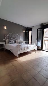 a bedroom with a white bed in a room at Apartamentos Turísticos ENCANTO in Cáceres