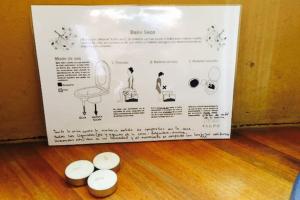 a sign with four white objects on a wooden floor at Malva Rosa Relax La Juanita in José Ignacio