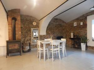 a dining room with a table and a wood stove at Chaloupka která má šmrnc in Čáslav