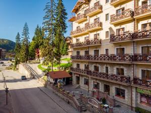 a building with balconies on the side of a street at Patkovski in Bukovel