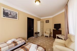 a living room with two beds and a tv at Patkovski in Bukovel