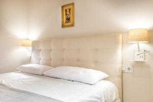 A bed or beds in a room at Dossau By Totiaran