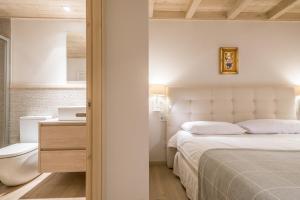 A bed or beds in a room at Dossau By Totiaran