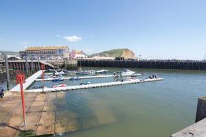 a group of boats docked at a dock in the water at Westpoint Apartments in West Bay