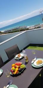 a table with a bowl of fruit and wine glasses at Villa Amazing View - S in Albufeira