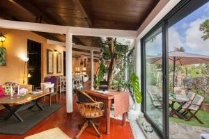 a home office with a table and chairs and a patio at Casa Finca Doñana in Arucas