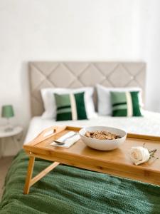 a bowl of food on a wooden tray on a bed at The Palms Apartment - Sun & Sea Madeira in Madalena do Mar