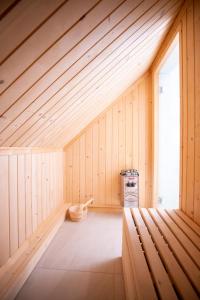 a sauna with a wooden ceiling and a window at Willa pod Halą Krupową in Skawica