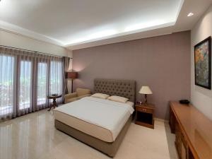 a bedroom with a bed and a large window at Via Renata Prapanca in Jakarta