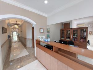 a lobby with a reception counter in a building at Via Renata Prapanca in Jakarta