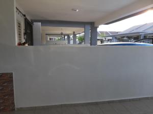 a white wall in front of a house at Rumah Armand Melaka 4BR Fully Aircond in Malacca