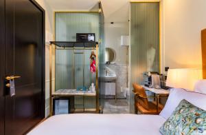 a hotel room with a bed and a bathroom at Villa Brown Tel-Aviv, a member of Brown Hotels in Tel Aviv