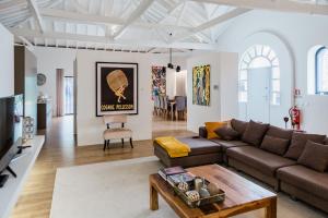 a living room with a couch and a table at casasun777, deixe-se surpreender e deslumbrar! in Braga